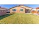 Backyard featuring a manicured lawn and mature plants at 18581 W College Dr, Goodyear, AZ 85395