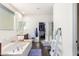 Bathroom featuring a soaking tub and a separate shower, with a walk-in closet at 18581 W College Dr, Goodyear, AZ 85395