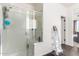 Glass-enclosed shower with bright white walls, a linen ladder, and neutral-toned floors at 18581 W College Dr, Goodyear, AZ 85395