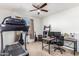 Spacious bedroom with a treadmill and a desk featuring office equipment at 18581 W College Dr, Goodyear, AZ 85395
