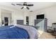 Main bedroom boasts a ceiling fan, an ensuite bathroom, a walk-in closet, and neutral paint at 18581 W College Dr, Goodyear, AZ 85395