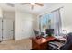 Bedroom with an office setup and a ceiling fan for added comfort at 18581 W College Dr, Goodyear, AZ 85395