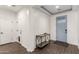 Inviting foyer with wood-look tile flooring, a stylish table, and a light blue front door at 18581 W College Dr, Goodyear, AZ 85395