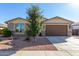 Charming single-story home featuring a well-maintained landscape and a two-car garage at 18581 W College Dr, Goodyear, AZ 85395