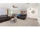 Open-concept living space featuring cozy sofas and a view of the modern kitchen at 18581 W College Dr, Goodyear, AZ 85395