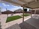 Backyard patio with artificial grass and privacy fence at 18629 W Fulton St, Goodyear, AZ 85338