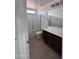 Bathroom with a glass shower, toilet, vanity, and a sun light above shower at 18629 W Fulton St, Goodyear, AZ 85338