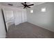 Bedroom with carpet flooring, a ceiling fan, a closet with sliding doors, and two small square windows at 18629 W Fulton St, Goodyear, AZ 85338