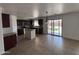 Modern kitchen with stainless steel appliances, granite countertops, dark wood cabinetry, and kitchen island at 18629 W Fulton St, Goodyear, AZ 85338