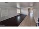 Spacious living room featuring dark wood flooring, white walls, and natural light from two windows with blinds at 18629 W Fulton St, Goodyear, AZ 85338