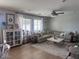 Comfortable living room area with large sofa, neutral color palette, and lots of natural light at 18629 W Fulton St, Goodyear, AZ 85338