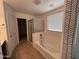 Bright main bathroom with a soaking tub, glass shower, and large window at 18629 W Fulton St, Goodyear, AZ 85338