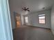 Spacious main bedroom with carpet, ceiling fan, and natural light from two windows at 18629 W Fulton St, Goodyear, AZ 85338