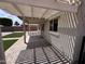 Covered backyard patio with view of grassy yard and privacy fence at 18629 W Fulton St, Goodyear, AZ 85338