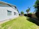 Spacious backyard with a well-maintained lawn, privacy fence, and mature trees providing ample shade at 19160 E Canary Way, Queen Creek, AZ 85142