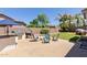 Outdoor patio area with a built-in grill, fire pit, seating area, and lush green lawn at 19160 E Canary Way, Queen Creek, AZ 85142