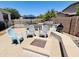 Outdoor patio with a built-in BBQ, fire pit, bar seating, and a refreshing pool beyond a safety fence at 19160 E Canary Way, Queen Creek, AZ 85142