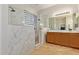 Modern bathroom featuring a glass-enclosed shower, double vanity sinks, and elegant tile work at 19160 E Canary Way, Queen Creek, AZ 85142