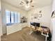 This carpeted bedroom features an adjustable desk and ceiling fan for comfort at 19160 E Canary Way, Queen Creek, AZ 85142