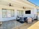 Outdoor patio featuring comfortable seating, ceiling fans, and a mounted TV, perfect for entertaining at 19160 E Canary Way, Queen Creek, AZ 85142