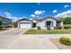 Charming single-story home with a well-manicured lawn and a two-car garage under a beautiful blue sky at 19160 E Canary Way, Queen Creek, AZ 85142