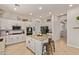 Bright kitchen featuring a center island, white cabinetry, stainless steel appliances, and tile flooring at 19160 E Canary Way, Queen Creek, AZ 85142