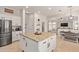 Spacious open kitchen with a center island, stainless steel appliances, and a seamless flow to the dining area at 19160 E Canary Way, Queen Creek, AZ 85142