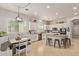 Well-lit open kitchen with an island, modern appliances, and a dining area with a wooden table at 19160 E Canary Way, Queen Creek, AZ 85142