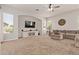 Spacious living room featuring neutral tones, a large sectional sofa, and a modern entertainment center at 19160 E Canary Way, Queen Creek, AZ 85142