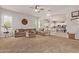 Open-concept living room with plush sofa flowing into a modern kitchen, perfect for entertaining and Gathering time at 19160 E Canary Way, Queen Creek, AZ 85142
