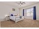 Serene main bedroom with natural light, features a ceiling fan, and neutral tones at 19160 E Canary Way, Queen Creek, AZ 85142
