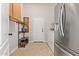 Functional mud room with built-in bench, storage cabinets, and easy access to laundry appliances at 19160 E Canary Way, Queen Creek, AZ 85142