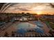 Aerial shot of large resort-style pool and deck area with plenty of seating and umbrellas at 20025 W Campbell Ave, Buckeye, AZ 85396