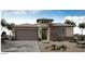 Charming single-story home featuring a stone facade, desert landscaping, and a two-car garage at 20025 W Campbell Ave, Buckeye, AZ 85396