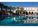 Beautiful pool with palm trees reflected in the water and lounge chairs at 20025 W Campbell Ave, Buckeye, AZ 85396
