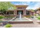 Exterior of the Edge clubhouse with stone accents, well-maintained landscaping, and a decorative water fountain at 20100 N 78Th Pl # 1023, Scottsdale, AZ 85255
