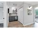 Hallway with a stylish bar area featuring a beverage cooler, shelving and a convenient closet at 20100 N 78Th Pl # 1023, Scottsdale, AZ 85255