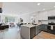 Open-concept kitchen featuring stainless steel appliances, stylish cabinets, and a view of the living room at 20100 N 78Th Pl # 1023, Scottsdale, AZ 85255