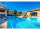 A sparkling community pool with inviting blue water, surrounded by lounge chairs and lush landscaping at 20100 N 78Th Pl # 1023, Scottsdale, AZ 85255