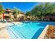 Relaxing community pool with clear blue water, surrounded by comfortable lounge chairs and manicured landscaping at 20100 N 78Th Pl # 1023, Scottsdale, AZ 85255