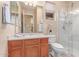 Cozy bathroom featuring a glass shower, wood vanity, and neutral color palette at 20283 N 273Rd Ave, Buckeye, AZ 85396