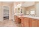 Double vanity bathroom featuring tile floors, updated lighting, and a walk-in shower at 20283 N 273Rd Ave, Buckeye, AZ 85396