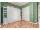 Bedroom featuring laminate floors and a large white storage cabinet with sliding closet door at 20283 N 273Rd Ave, Buckeye, AZ 85396