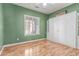 Bright bedroom with a large window, wood floors, and built in cabinet storage at 20283 N 273Rd Ave, Buckeye, AZ 85396