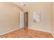 Empty bedroom with hardwood floors and ensuite bathroom access at 20283 N 273Rd Ave, Buckeye, AZ 85396