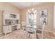 Dining room with charming chandelier and a built-in desk at 20283 N 273Rd Ave, Buckeye, AZ 85396