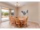 Bright dining area with chandelier and sliding glass door to yard at 20283 N 273Rd Ave, Buckeye, AZ 85396