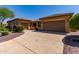 Expansive driveway connects two garages, framed by meticulous desert landscaping, enhancing curb appeal and functionality at 20283 N 273Rd Ave, Buckeye, AZ 85396