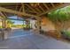 Inviting entrance to a building, featuring stone columns and a wooden bench, enhancing curb appeal and accessibility at 20283 N 273Rd Ave, Buckeye, AZ 85396