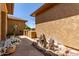 Charming exterior view with a rock garden, desert landscaping, and unique architectural details, blending seamlessly with nature at 20283 N 273Rd Ave, Buckeye, AZ 85396